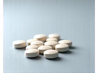 Joint support supplement pills on a wooden surface